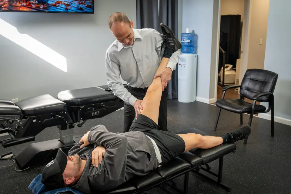 A chiropractor treating a patient at Health and Fitness Professionals