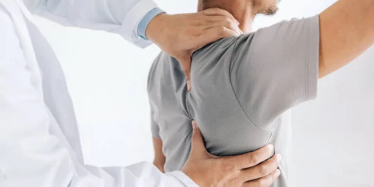 image of a man getting his shoulder adjusted by a chiropractor